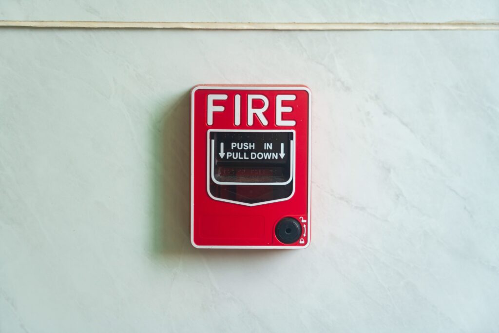 Image of a wall mounted red fire alarm device for safety alerts and emergency preparedness.