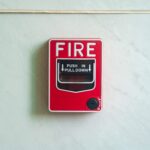 Image of a wall mounted red fire alarm device for safety alerts and emergency preparedness.